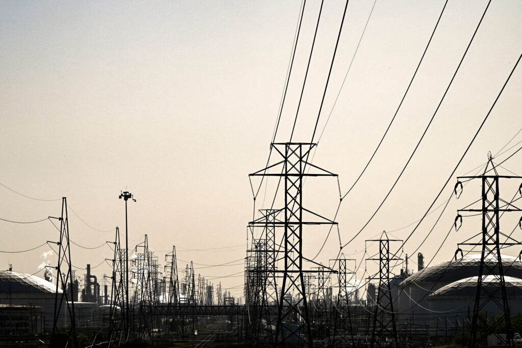 Senate Democrats Blame Trump’s Assault on Clean Energy for High Electricity Prices Transmission lines lead to an oil refinery in Deer Park, Texas. Credit: Ronaldo Schemidt/AFP via Getty Images
